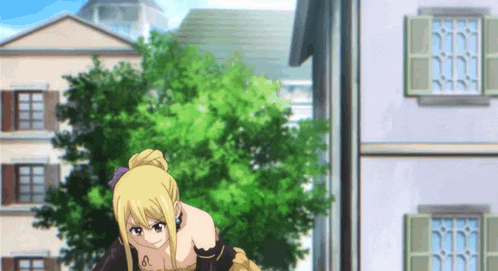 a woman in a dress is bending over in front of a building .