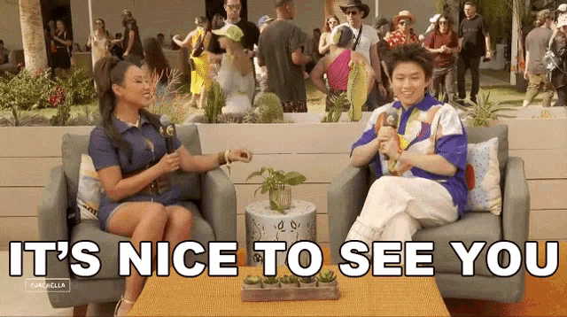 a man and a woman are sitting on a couch talking to each other with the words it 's nice to see you .