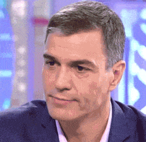 a close up of a man 's face with a blue background