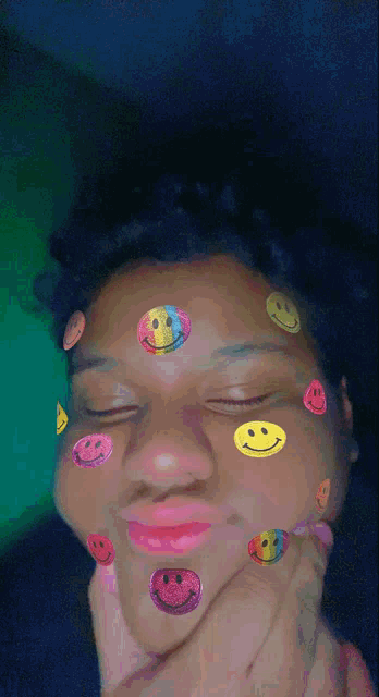 a girl with smiley faces on her face making a funny face