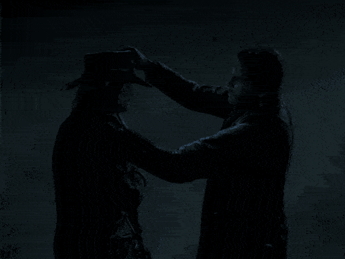 a man in a cowboy hat is putting his hand on another man 's shoulder