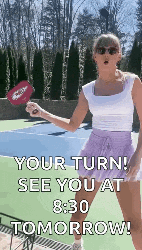 a woman is holding a paddle on a tennis court and says `` your turn ! see you at 830 tomorrow ! ''
