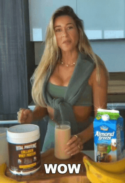 a woman drinking a vital proteins collagen whey protein drink