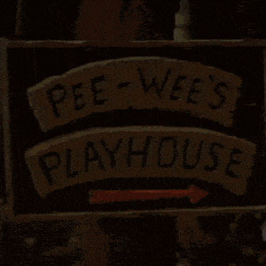a sign for pee-wee 's playhouse has a red arrow pointing to the right