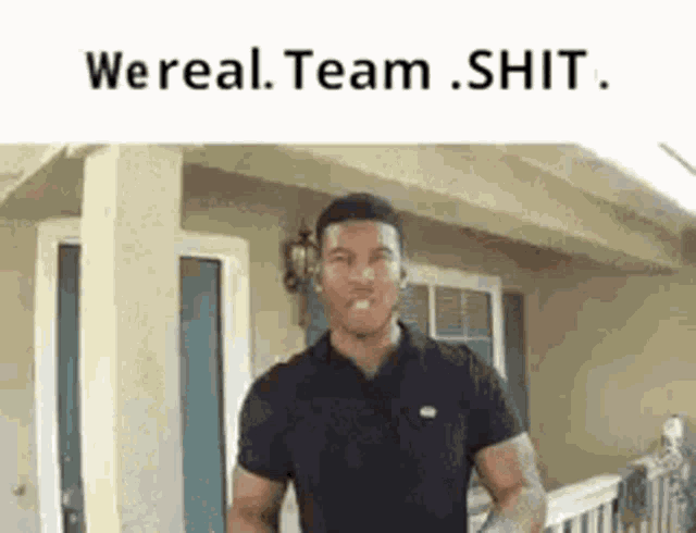 a man in a black shirt is standing in front of a house with the words `` we real team shit '' above him .