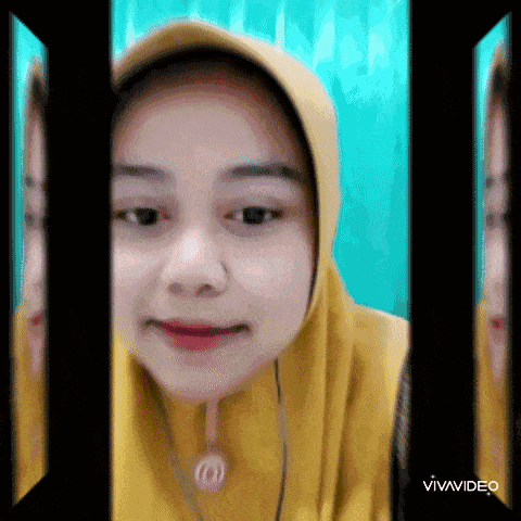 a woman wearing a yellow hijab and a necklace is looking at the camera .