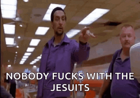 a man in a purple shirt is pointing at another man in a purple shirt .