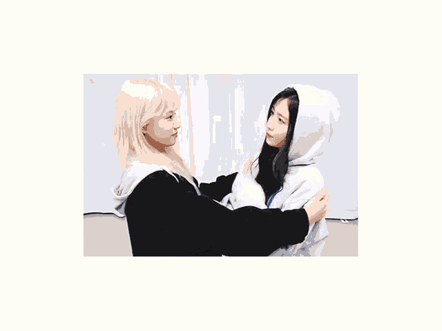 two girls are giving each other a high five and one of them is wearing a hoodie that says ae