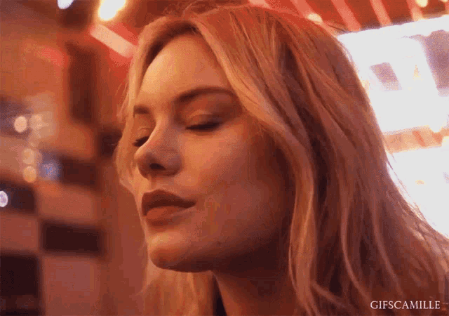 a close up of a woman 's face with the words gifscamille written below her