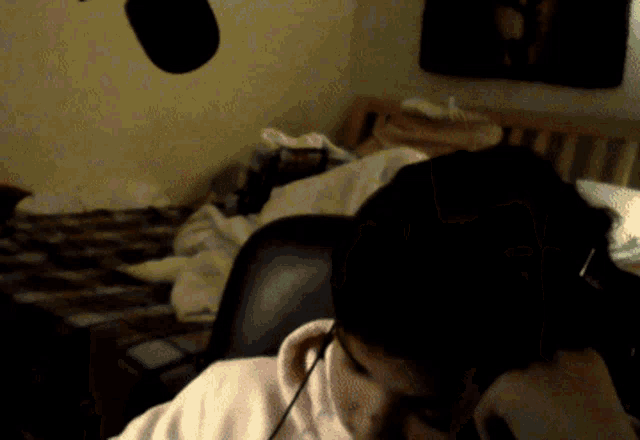 a person wearing headphones sits in a chair