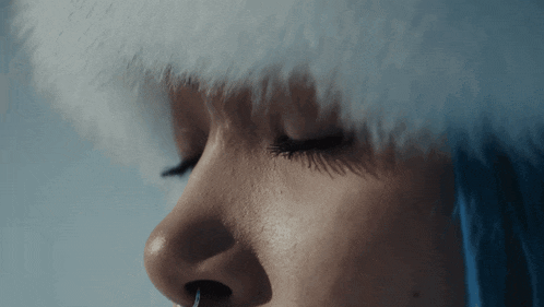 a close up of a woman 's face with a nose ring