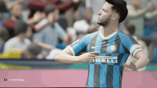 a soccer player wearing a blue and black jersey with the word irelli on it