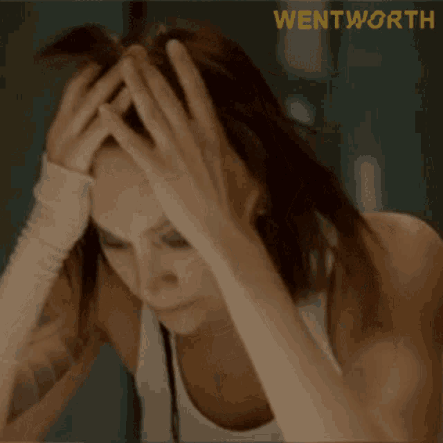 a woman with her hands on her head with the word wentworth in the corner