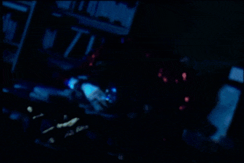 a close up of a person 's face with a blue light behind them