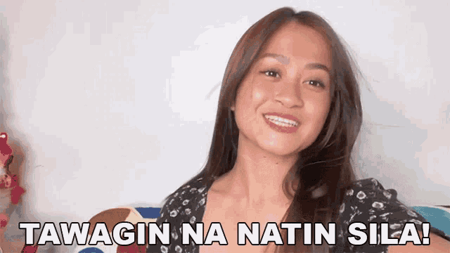 a woman is smiling with the words tawagin na natin sila