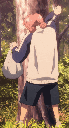 a person standing next to a tree with a bag on their back
