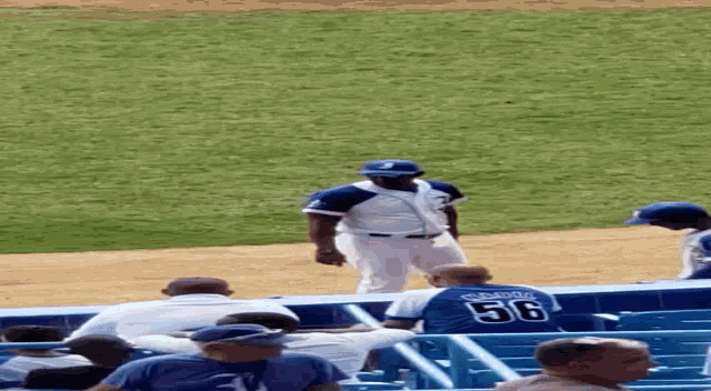 a baseball player wearing a number 89 jersey stands on the field