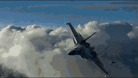 a fighter jet is flying through the clouds .