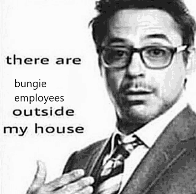 a black and white photo of a man wearing glasses and a suit .