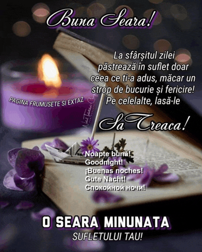an open book with purple flowers and a purple candle on it