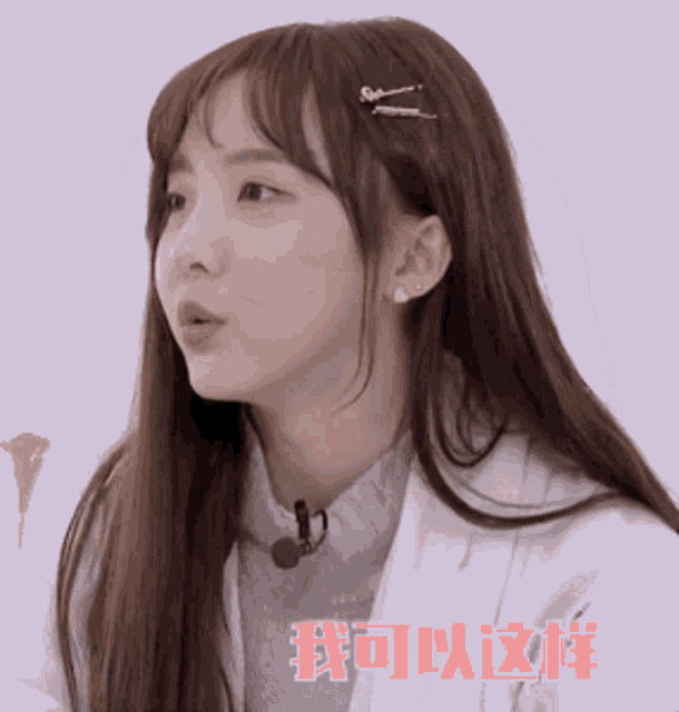 a girl with long hair is wearing a white coat and a microphone in her hair ..