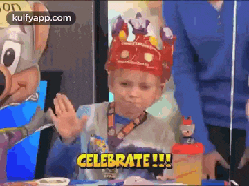 a young boy wearing a crown says celebrate !!!