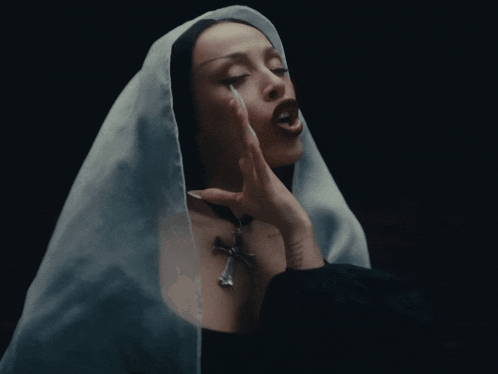 a woman wearing a white veil is praying