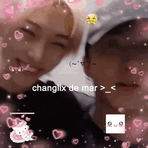 a couple of people are standing next to each other and smiling with hearts around them .