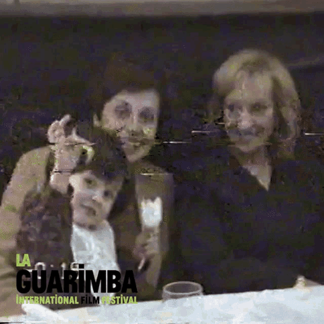 a group of people are sitting at a table and the words guarimba international film festival are on the bottom