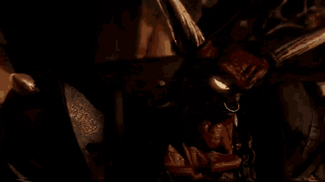 a demon with horns is holding a sword