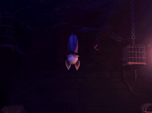 a purple and white bat hanging upside down in a dark room