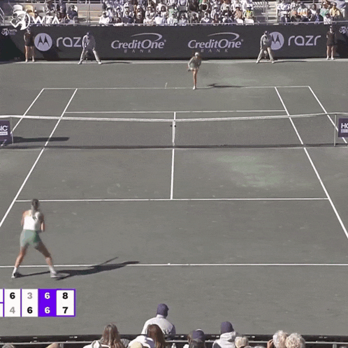 a tennis match is being played on a court sponsored by razor