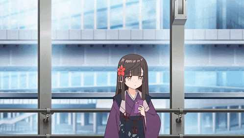 a girl with a flower in her hair is looking at her cell phone