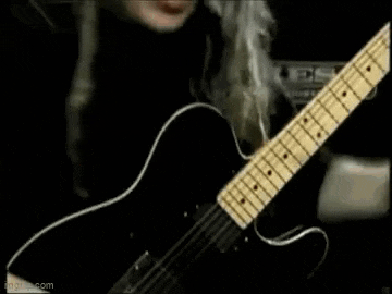 a man is playing a guitar with the words wow written on the screen .
