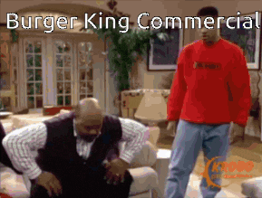 a man in a red shirt is standing next to another man in a living room with the caption burger king commercial