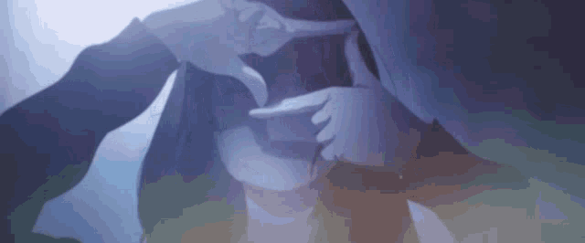 a person holding another person 's hand in a dark room .