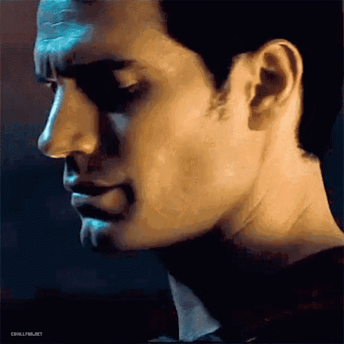a close up of a man 's face with his eyes closed and a serious look on his face .