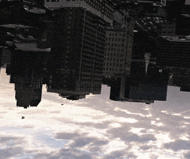 an upside down view of a city with a building that says ' ubc ' on it