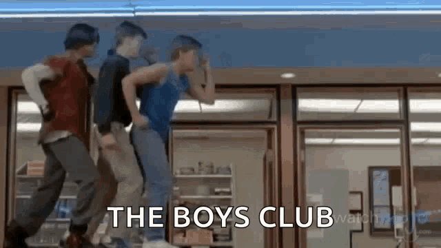three boys are dancing in front of a store with the words `` the boys club '' written above them .