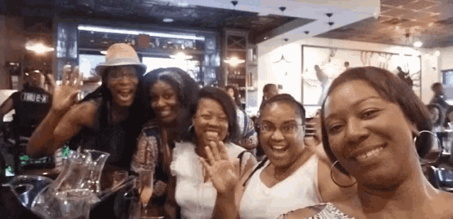 a group of women are posing for a picture in a restaurant