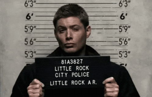 a man holding up a little rock city police mugshot