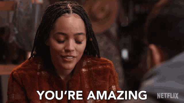 a woman with braids says you 're amazing in front of a man