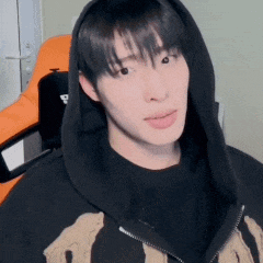 a young man wearing a black hoodie and a black shirt
