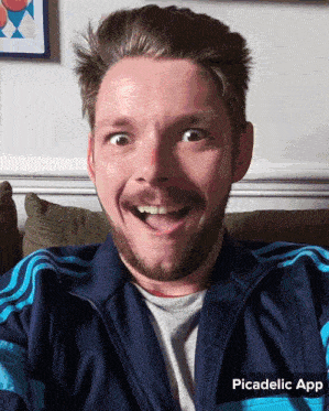 a man with a beard is making a funny face and the picadelic app is displayed below him