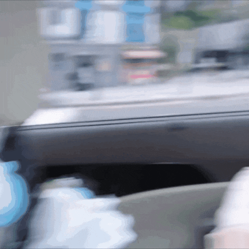 a blurry picture of a car driving down a street