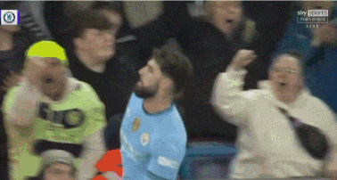 a man in a blue shirt with the word city on it is surrounded by a crowd