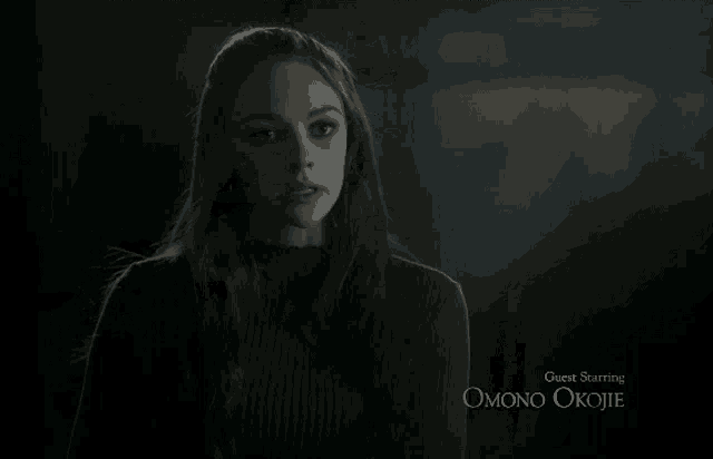 a woman in a dark room with guest starring omono okojie