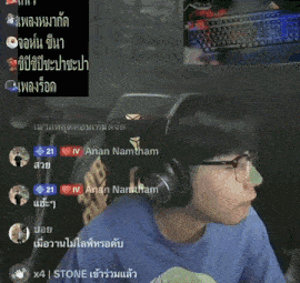 a man wearing headphones and glasses is sitting in front of a keyboard in a room