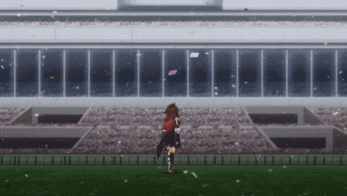 a girl with red hair is standing on a field in front of a stadium