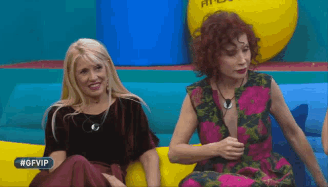 two women are sitting next to each other with the hashtag #gfvip in the corner